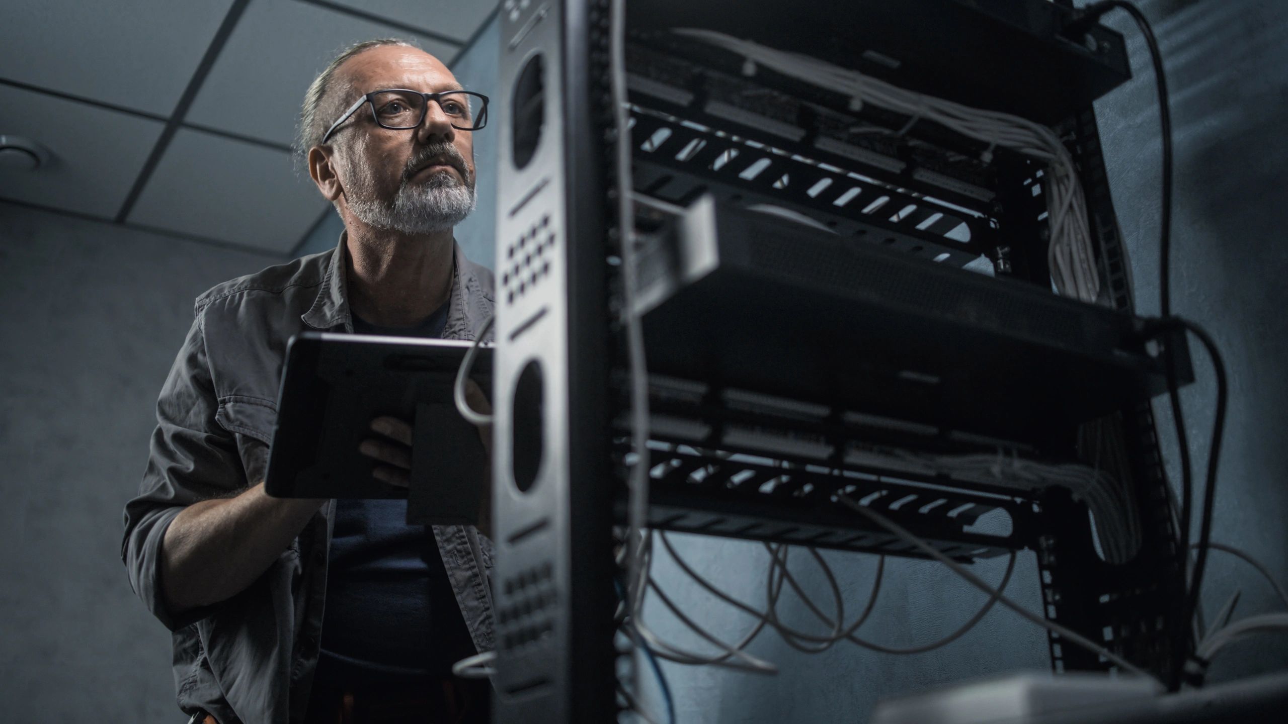 Technician working with security system equipment in a server room